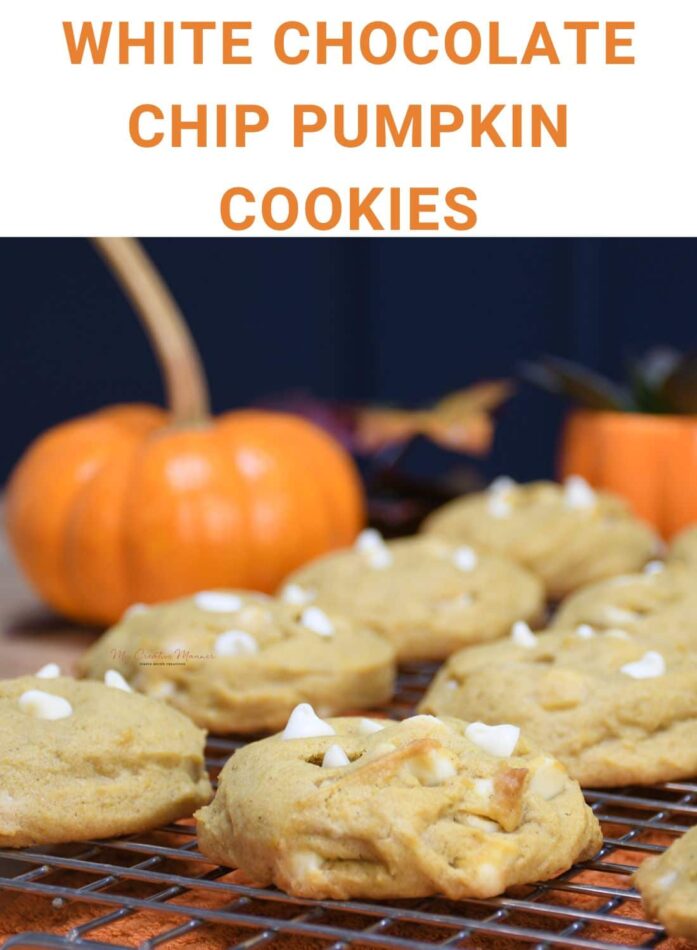 A close up of pumpkin cookies with white chocolate chips on a cooling rack.
