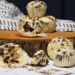 A close up of mini chocolate chip muffins on a board.