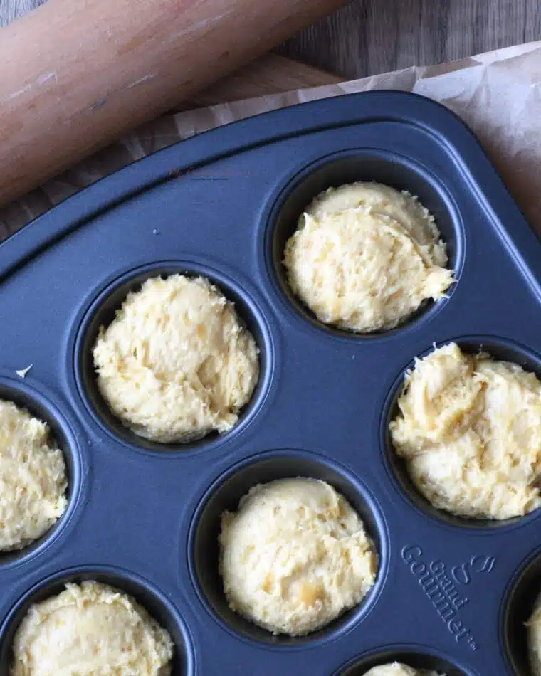 Overhead shot of a muffin tin with banana muffins in it.