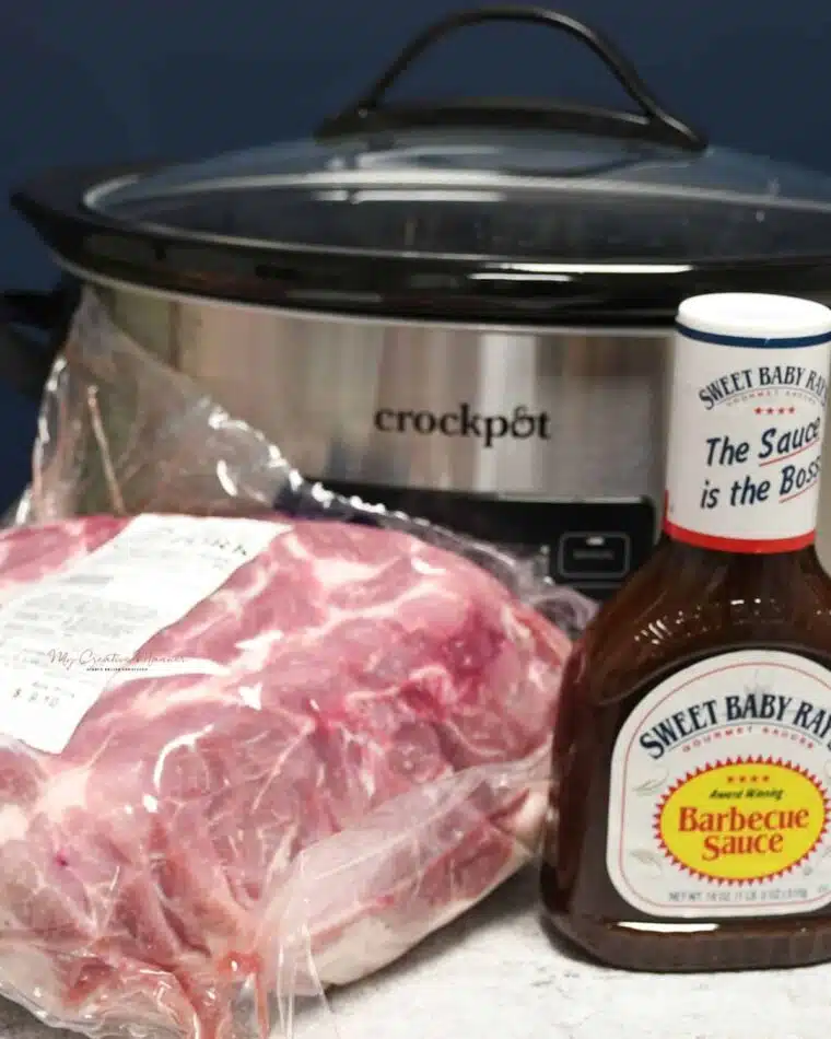 A slow cooker and the two ingredients that are needed to make this pulled pork recipe.