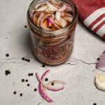 Overhead view of a jar filled with pickled red onions.