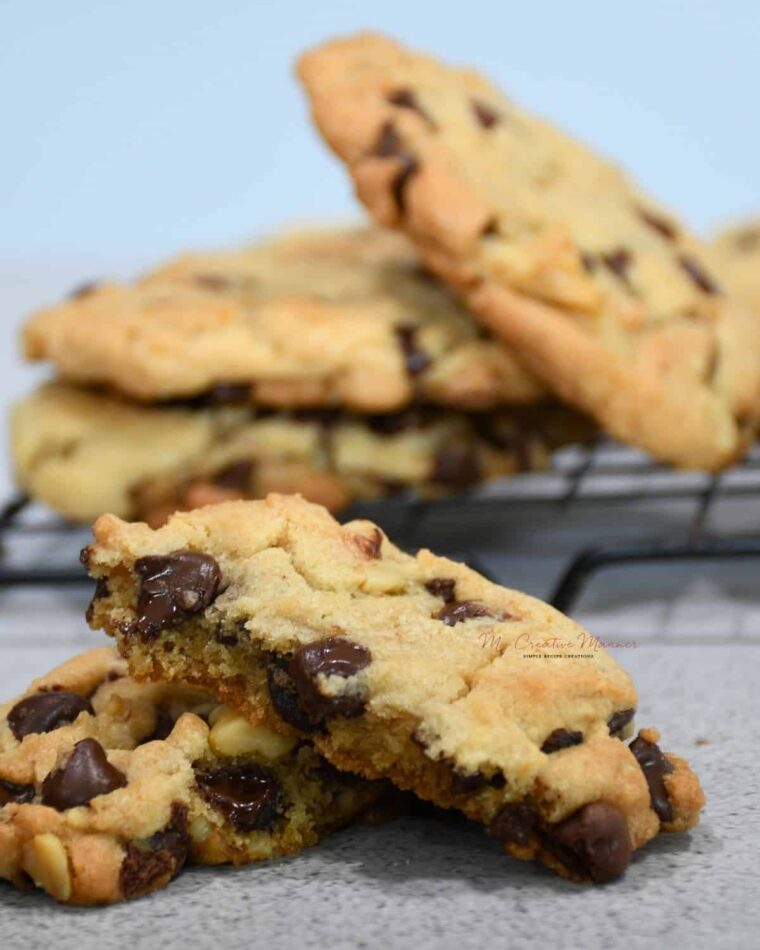 A close up of a chocolate chip cookie with walnuts.