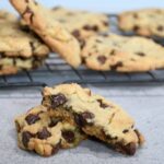 A chocolate chip walnut cookie that is split in half.