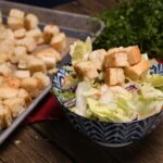 A salad that is topped with homemade croutons.