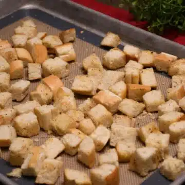 A baking sheet pan with baked homemade croutons.