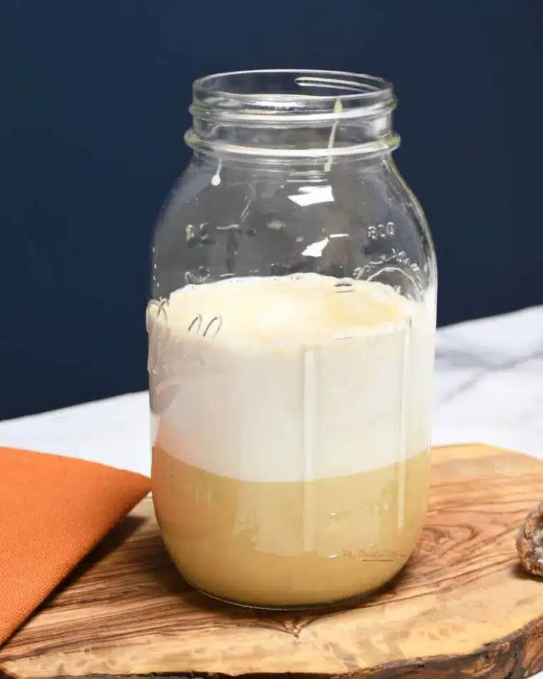 A mason jar that has sweetened condensed milk and half and half in it for coffee creamer.