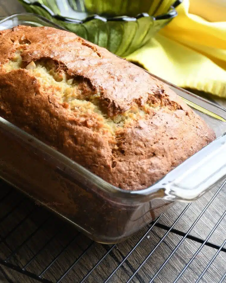 A baked loaf of the banana coconut bread with pineapple that hasn't been sliced yet.