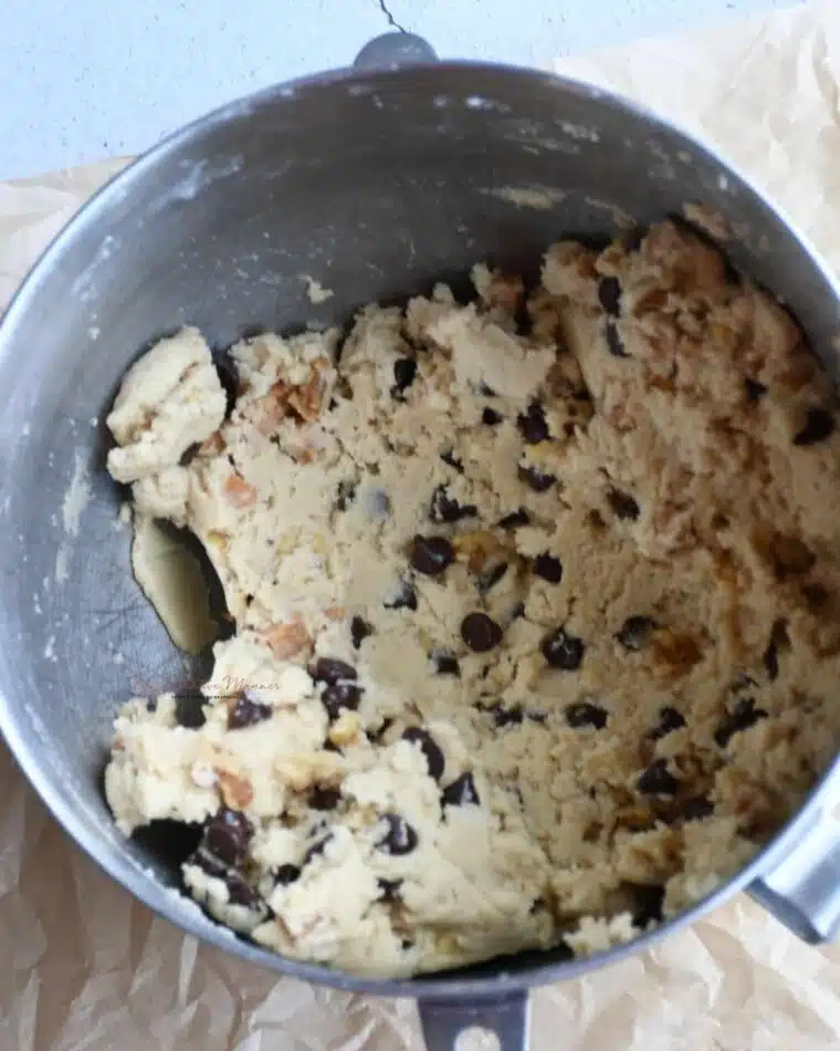 Overhead shot of the cookie dough that is filled with caramel pieces, chocolate chips, and walnuts.