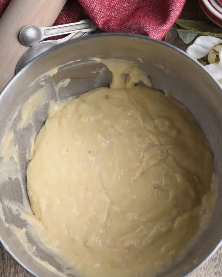 The inside of a large mixing bowl that has the banana bread batter in it.