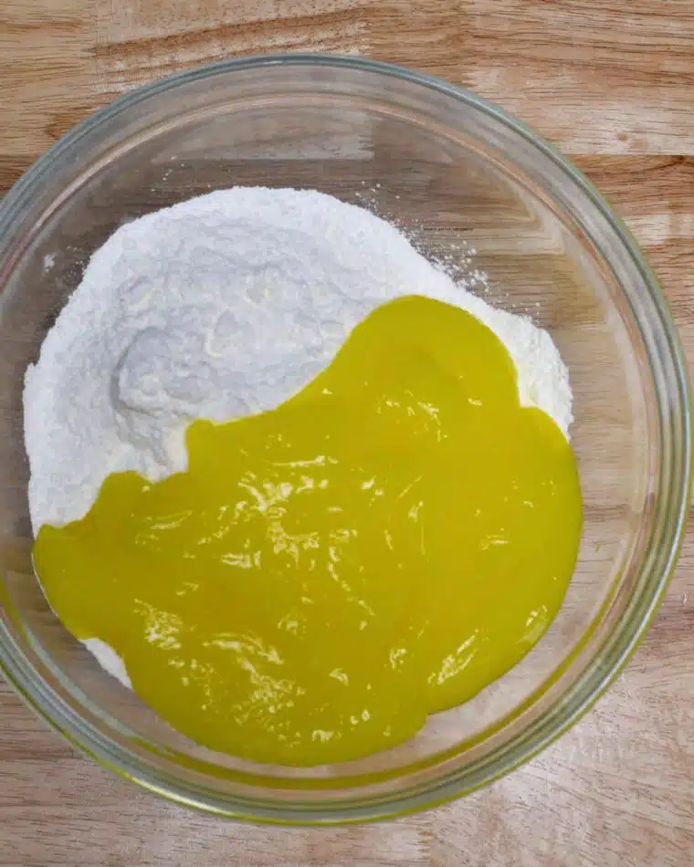 A bowl filled with the two ingredients for lemon bars.