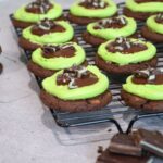 A close up of the grasshopper cookies on a cooling rack.