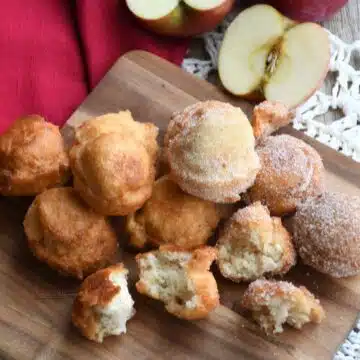 Overhead shot of 2 ingredient apple donuts on a wood plate.