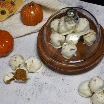 Overhead image of a platter that has the cheesecake pumpkin spice bites on it and more in front of the platter.