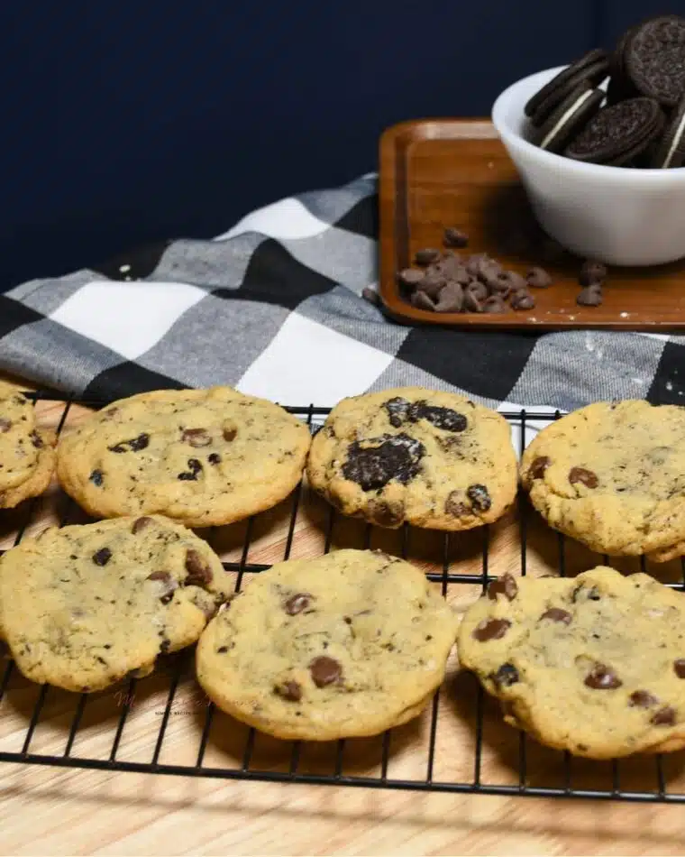 A wire cooling rack filled with Oreo chocolate chip cookies.