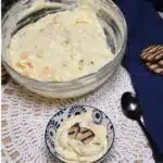 Overhead image of a large bowl and a smaller bowl that has the fluff salad with cookies in it.