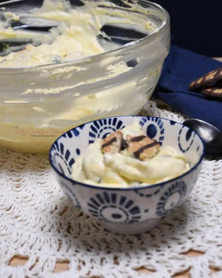 A small bowl with the cookie salad in it and more in a large bowl.