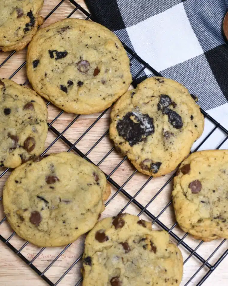 Overhead image of chocolate chip cookies with oreos on a wire cooling rack.