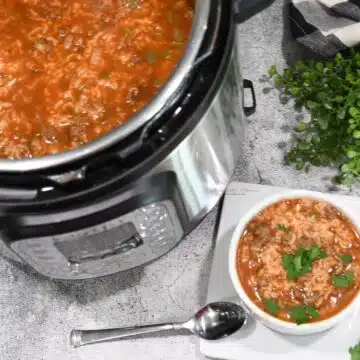 Overhead image of a n Instant Pot and a bowl that are filled with stuffed pepper soup.