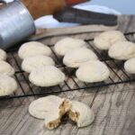 Gingerbread cookies that are free of molasses on a cooling rack with on on a counter that has been split open.