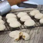 Gingerbread cookies that are free of molasses on a cooling rack with on on a counter that has been split open.