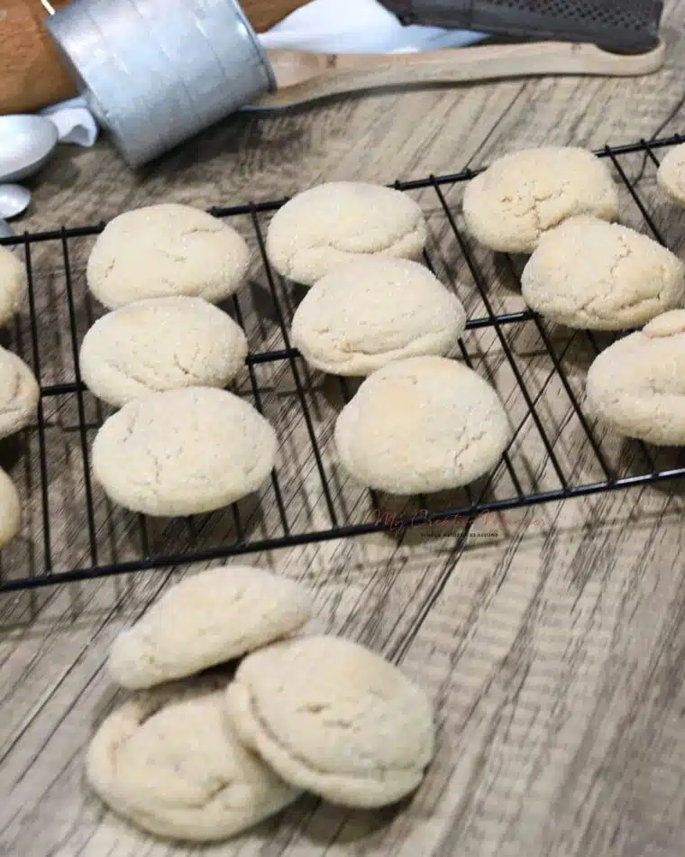 The no molasses cookies on a cooling rack with more gingerbread treats in front of the rack.