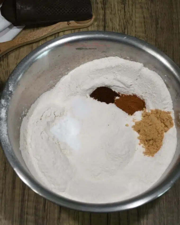 A bowl that has flour, and spice in it for the gingerbread cookies.