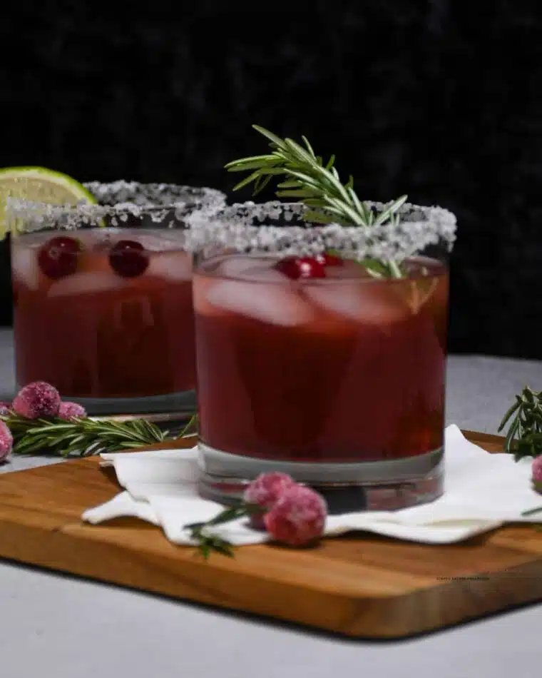 Two cocktail glasses filled with a delightful cranberry margarita drink.