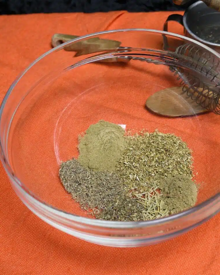 Overhead image of a bowl with the spices to make homemade Italian seasoning.
