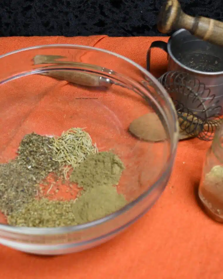 Front view of a bowl that has the Italian seasoning mix in it.