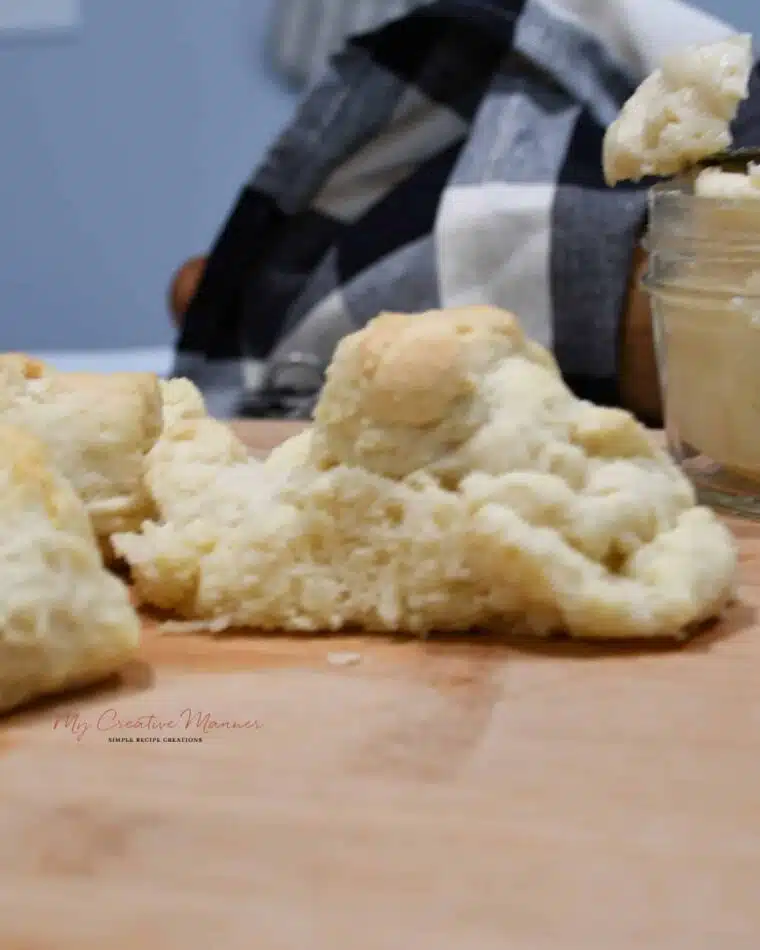 A homemade biscuit on a wood platter.