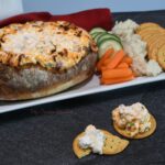 Crackers that have the sinful dip on them with a bread bowl that is filled with more of the Mississippi dip.