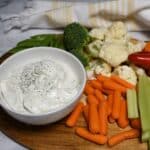 A veggie platter with a small white bowl that is filled with teh cottage cheese ranch dip recipe.