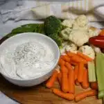 A veggie platter with a small white bowl that is filled with teh cottage cheese ranch dip recipe.