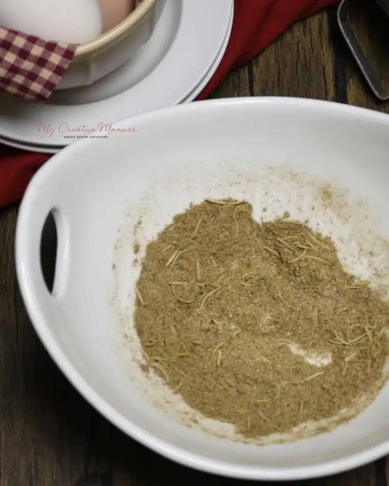 A mixing bowl with blended poultry seasoning in.