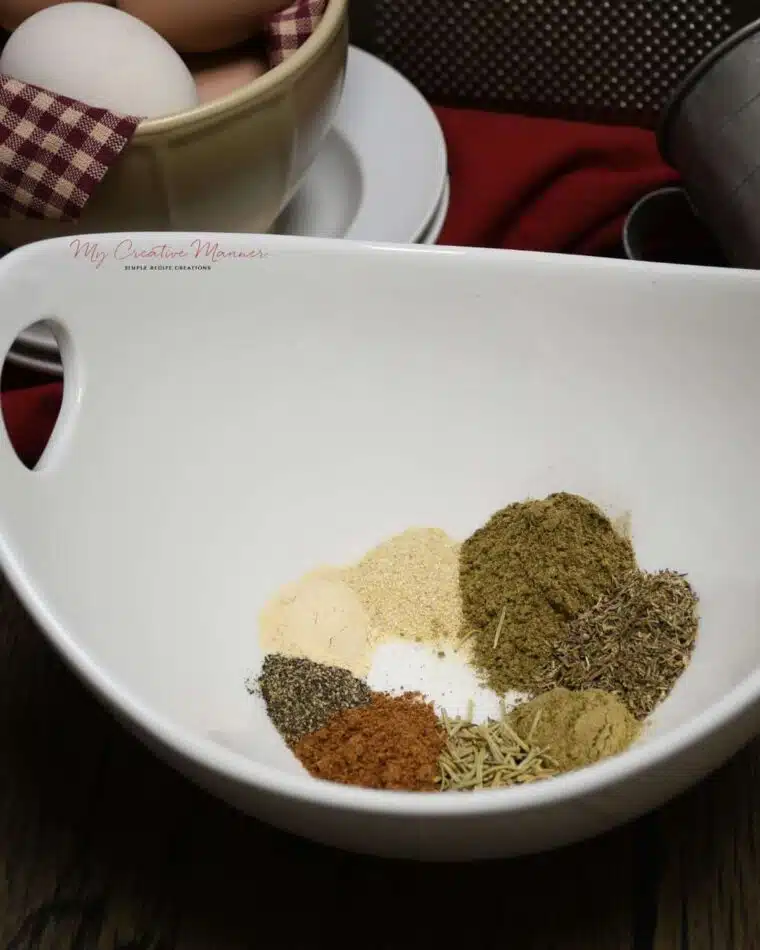 A white bowl filled with the seasonings for homemade chicken seasoning.