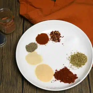 A plate that has the spices on it to make homemade Cajun seasoning.