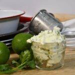 Looking at a jar that is filled with the cilantro butter with lime.