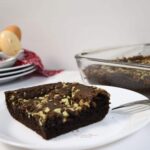 A whit eplate with a fork that has a slice of the grasshopper chocolate mint cake.
